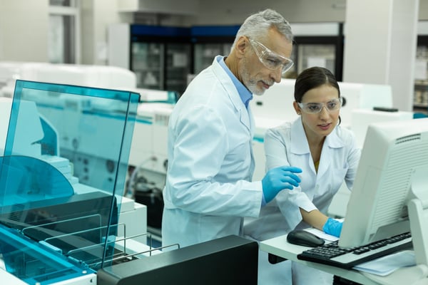 Lab Techs at computer